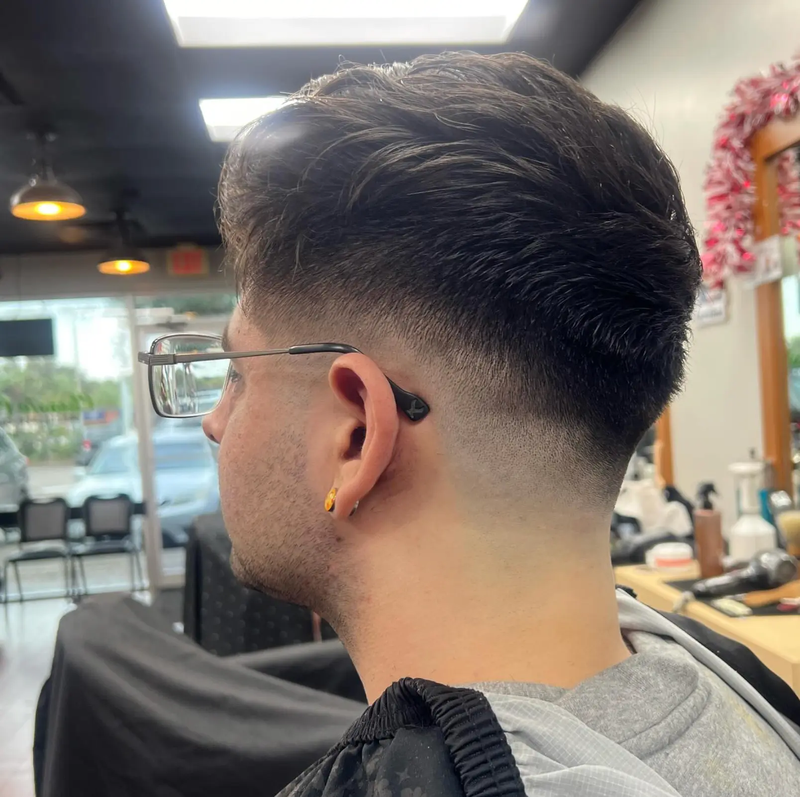 High skin fade blended into a fuller top
